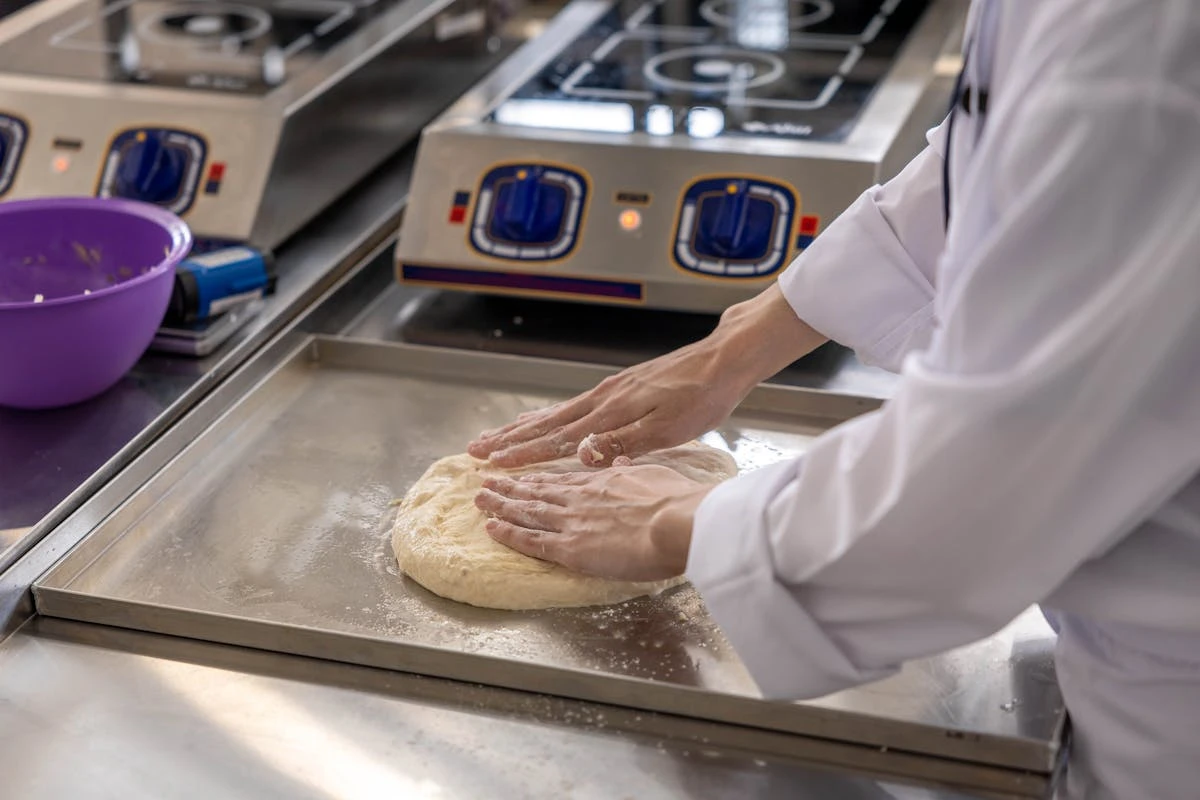 Baker shaping dough by hand
